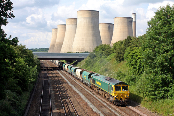 Feightliner 66607 is seen at Ratcliffe on Soar, MML on 16.6.16 with 6V08 1327 Tunstead Sdgs - Brentford Town Days loaded stone hoppers. The Cooling Towers of Ratcliffe P.S. oversees the movement