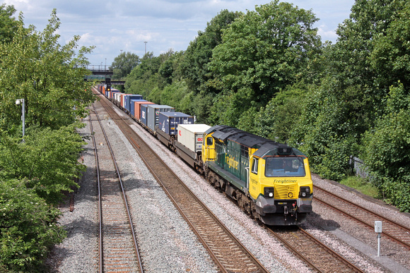 Freightliner 70010 at its signal check awaiting time at Long Eaton, just south of Toton Yard, on 21.6.16  with 4O95 12.12 Leeds F.L.T. - Southampton M.C.T. liner