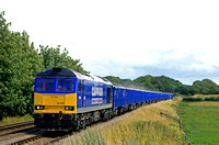 DC Rail Class 60 No 60028 in blue Cappagh livery at Rearsby heading towards Syston East Junction on 15.7.23 with 6M89 0901 Middleton Towers to Ravenhead Sdgs loaded sand blue box wagons