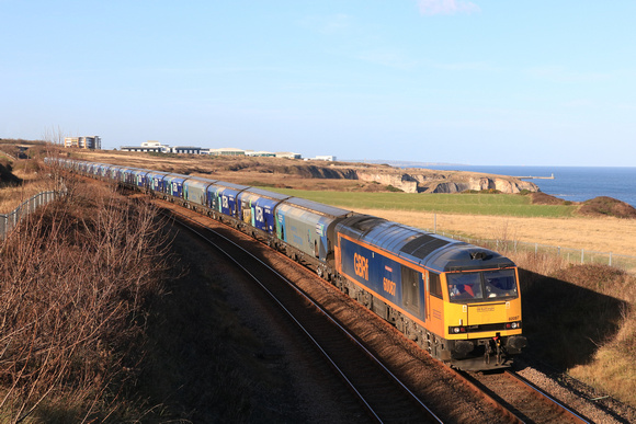 GBRf Class 60 No 60087 Ingleborough heads along the beautiful Durham Coast south of Seaham on 11.11.24 with 6H70 1219 Tyne Coal Terminal Gbrf to Drax Aes (Gbrf) loaded Biomass hoppers