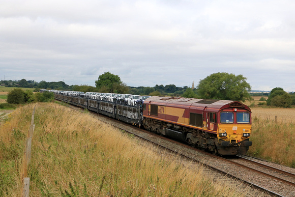 DB Cargo Class 66 No 66174 passes Copley's Brook, Melton Mowbray on 28.7.23 with 6X11 0700 Toton North Yard to Dollands Moor Sdgs well loaded Toyota car train