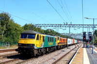 Freightliner Class 90 No's 90049 in Powerhaul livery & 90015 in G & W orange livery race through Colchester Station on 10.8.23 with 4M87 1113 Felixstowe North F.L.T. to Trafford Park F.L.T. Intermodal