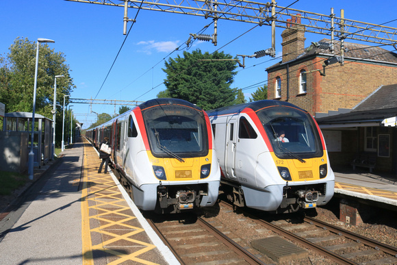GA Class 720 units wait at Hatfield Peverel station on 9.8.23. On left 720545 works 1F32 1632 London Liverpool Street to Colchester Town, right 720572 1F53 1636 Colchester Town to London Liverpool Str