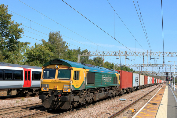 Freightliner Class 66 No 66504 in Powerhaul livery races through Colchester Station on 10.8.23 with 4M93 1313 Felixstowe North F.L.T. to Lawley Street F.L.T. Intermodal
