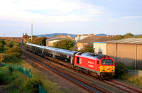 DB Cargo Class 67 No 67013 on hire to Transport for Wales passes Pensarn, Abergele on 8.7.24 at 8 49 pm with TfW 1W96 1714 Cardiff Central to Holyhead service
