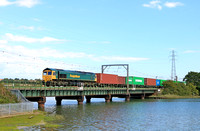 Freightliner Class 66 No 66545 crosses Cattawade Bridge, Brantham over the River Stour on 16.8.23 with 4M87 1113 Felixstowe North F.L.T. to Trafford Park F.L.T. Intermodal