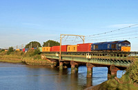 GBRf Class 66 No 66303 formerly DRS with no current branding crosses Cattawade Bridge over River Stour on 21.8.23 with  4M02 1738 Felixstowe North Gbrf to Hams Hall Gbrf Intermodal
