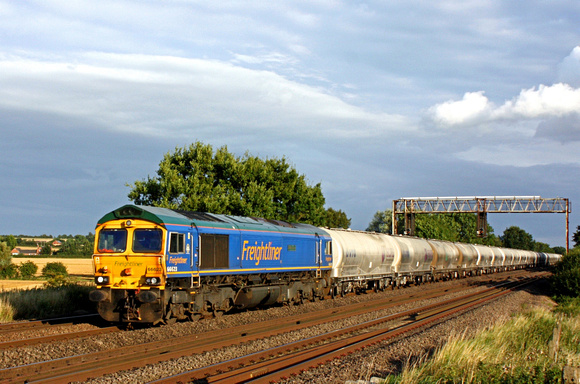 Freightliner 66623 'Bill Bolsover' in blue livery heads northwards at Cossington, MML on 9.8.17 with 6M84 1306 Dagenham Down Yard - Hope (Earles Sidings) empty cement tanks