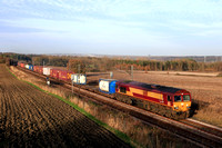 DB Cargo Class 66 No 66111 still carries old EWS livery seen at Plawsworth heading towards Durham on 12.11.24 with 4E96 0900 Mossend Euroterminal to Tees Dock Bsc Export Berth Intermodal