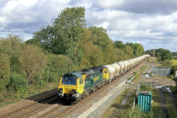 Freightliner Class 70 No 70016 powers away from Stenson Junction on 3.10.23 with 6G65 0919 Hope (Earles Sidings) Fhh to Walsall Freight Terminal loaded cement tanks