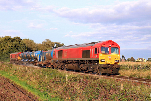 DB Cargo Class 66 No's 66070 and 66185 both in red livery pass East Goscote in low sun on 3.10.23 tnt with 3J43 1600 Peterborough L.I.P. to Peterborough L.I.P. RHTT working via Melton Mowbray and Loug
