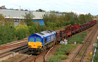 DB Cargo Class 66 No 66023 in 'Kings Coronation' blue livery at Leicester North on 17.10.23 with 6V92 1034 Corby B.S.C. to Margam T.C. empty steel wagons and mounts