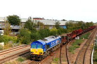 DB Cargo Class 66 No 66023 in 'Kings Coronation' blue livery approaches Leicester Station on 17.10.23 with 6V92 1034 Corby B.S.C. to Margam T.C. empty steel wagons and mounts