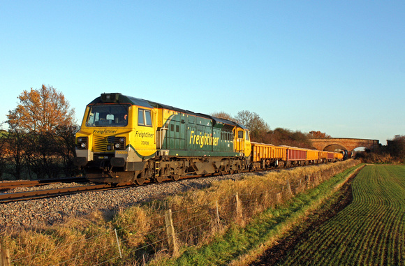 70006 at Barrow Upon Trent heading towards Stenson Junction on 4.12.13 with 6U77 1344 Mountsorrel Sidings - Crewe Basford Hall loaded ballast wagons in the low sun