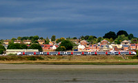 A GA Class 745 unit runs alongside the River Stour at Brantham on 4.10.22 seen from Mistley with 1P27 1000 Norwich to London Liverpool Street srvice (SMB)