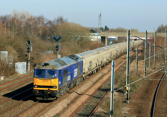 Beacon Rail blue liveried GBRf Class 60 No 60026 Helvellyn approaches Tyne and Wear Metro Pelaw station on 19.3.25 with 6N22 1351 Tyne Coal Terminal Gbrf to Lynemouth Power Stn (Gbrf) loaded Biomass h