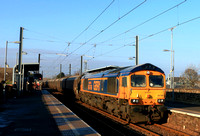 GBRf Class 66 No 66766 Gail Richardson passes through East Boldon Tyne & Wear Metro station on 18.1.25 with 6H70 1224 Tyne Coal Terminal Gbrf to Drax Aes (Gbrf) loaded Biomass hoppers