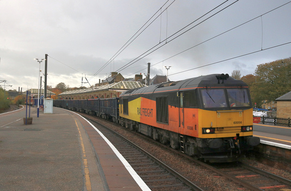 Colas Rail Class 60 No 60056 is seen at a dull and rainy Skipton station on 2.11.23 with 6E69 1254 Ribblehead Vq Gbrf to Hunslet Tilcon Gbrf loaded blue box wagons