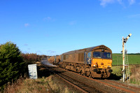 DRS  Class 66 No 66425 'Nigel J Kirchstein' at Haw Lane Crossing, Hellifield on 5.11.23 with 3S29 0827 York Thrall Europa to York Thrall Europa vua Hellifield Goods Loop RHTT working. DRS Class 66 No