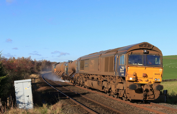 DRS  Class 66 No 66425 'Nigel J Kirchstein' nears Haw Lane Crossing, Hellifield on 5.11.23 with 3S29 0827 York Thrall Europa to York Thrall Europa via Hellifield Goods Loop RHTT working. DRS 66429 at