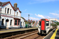 TfW Class 197  No 197024 passes through the station with the longest name  Llanfairpwllgwyngyllgogerychwyrndrobwllllantysiliogogogoch (Llanfairpwll) on 26.6.24 with 3Q74 1507 Crewe to Holyhead ECS mov