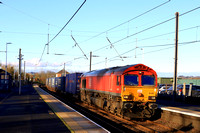 DB Cargo Class 66 No 66009 in red livery passes through Alnmouth station on 17.11.23 with 4E96 0900 Mossend Euroterminal to Tees Dock Bsc  Export Berth Intermodal