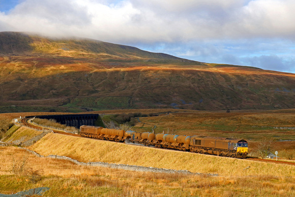 Looking somewhat worse for wear DRS Class 66's 66434  & 66433 head towards Ribblehead Viaduct on 26.11.18 with 3J11 1706½ Carlisle Kingmoor Tmd(Drs) to Carlisle Kingmoor Tmd(Drs) RHTT working