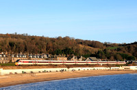 LNER Azuma Class 800 No 800107 skirts along the beach overlooking the  the Firth of Forth Coast at Burntisland, Fife on 6.12.23 with 1W02 0708 Leeds to Aberdeen service