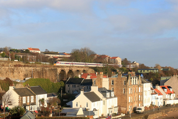 LNER Azuma Class 800 No 800104 'Celebrating Scotland' crosses Kinghorn Viaduct, Fife overlooking Pettycur Bay, heading north from Kinghorn station on 14.12.23 with 1W02 0708 Leeds to Aberdeen service