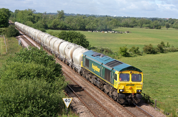 66595 seen from the Syston Bypass bridge heading towards Melton Mowbray in lovely  rural countryside  on 22.6.11 with 6L45 0737 Earles Sidings - West Thurrock loaded PCA cement tanks