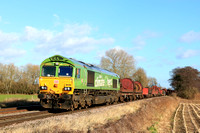DB Cargo 66004 in special  green “I am a Climate Hero” powers past East Goscote heading towards Syston East Junction on 26.1.24 with 6V92 1032 Corby B.S.C. to Margam T.C. empty steel coil wagons