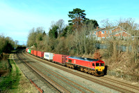 DB Cargo Class 66 No 66086 in red livery slowly passes Barrow upon Soar, MML on 20.2.24 with 4L38 1057 East Mids Gateway Tml Dbc to Felixstowe North Dbc Intermodal