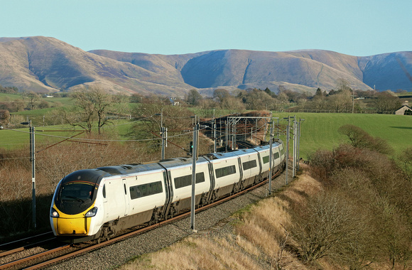 With a backcloth of the Howgill Fells, Avanti West Coast Pendolino Class 390 No 390049 at Docker, WCML on 18.1.20 with 1M12 1140 Glasgow Central to London Euston service