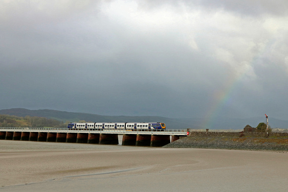 On an atrocious wet and windy day Northern Class 195 No 195102 crosses Arnside Viaduct  towards a rainbow on 28.1.20 with 1U96 1146 Barrow-in-Furness to Manchester Airport service