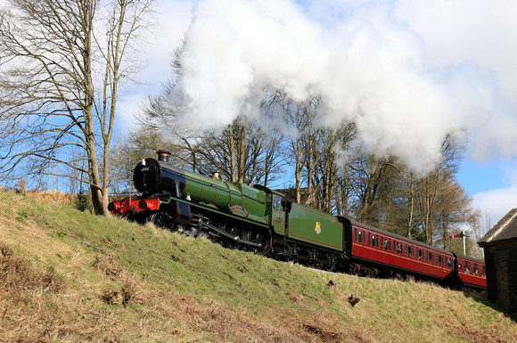 GCR guest loco GWR modified Hall 4-6-0 No.6990 'Witherslack Hall' climbs the steep gradient past Oakworth Mill on 24.3.24 with 1110 Keighley to Oxenhope at the K&WVR Steam Gala March 2024