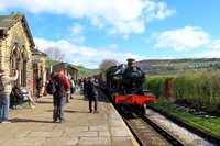 GCR guest loco GWR modified Hall 4-6-0 No.6990 'Witherslack Hall' waits at a busy Oakworth station on 24.3.24 with 1110 Keighley to Oxenhope at the K&WVR Steam Gala March 2024 (SMB)