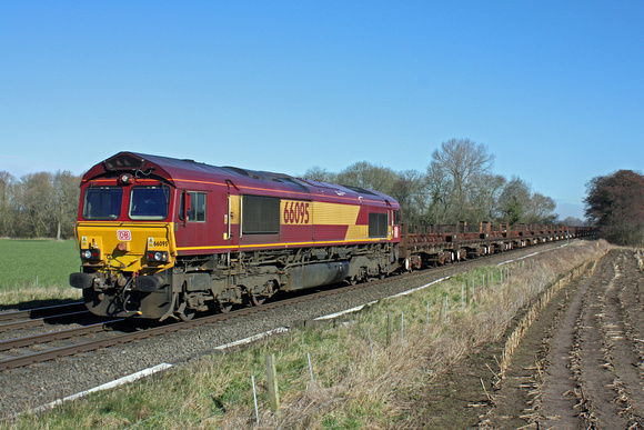 66095 with DB sticker purrs through East Goscote heading towards Syston East Junction on 24.2.16 with 6V92 1022 Corby B.S.C. - Margam T.C. empty steel coil wagons