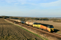 Colas Rail Class 70 No 70814 passes Plawsworth near Durham on 26.3.25 with 6D43 1541 Jarrow Prax to Lindsey Oil Refinery Colas empty bogie tanks