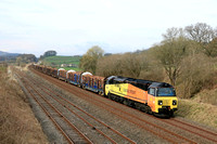 Colas Rail Freight Class 70 No 70810 passes Settle Junction on 26.3.24 with 6J37 1252 Carlisle Yard Colas Rail to Chirk Kronospan Colas Rail loaded log train