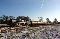 BR Standard Class 7 No 70013 'Oliver Cromwell' glints in the sun at a snowy Woodthorpe on 29.12.14 with 1300 Leicester North - Loughborough GCR Christmas Holiday Service