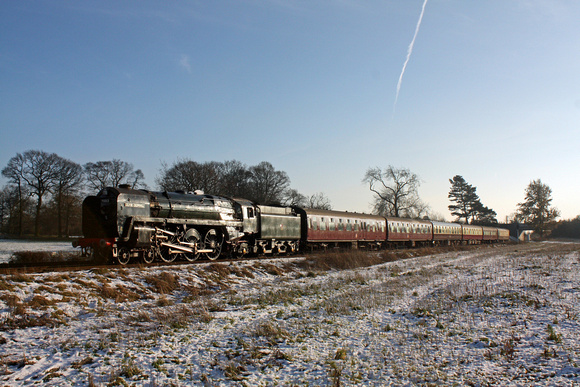 BR Standard Class 7 No 70013 'Oliver Cromwell' glints in the sun at a snowy Woodthorpe on 29.12.14 with 1300 Leicester North - Loughborough GCR Christmas Holiday Service