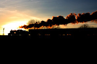 LMS Ivatt Class 2 2-6-0 No 46521 is silhouetted against  the setting sun approaching the signal at Quorn on 29.12.14 with 1515 Loughborough - Leicester North GCR Christmas Holiday Service