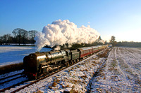BR Standard Class 7 No 70013 'Oliver Cromwell' glints in the sun at a snowy Woodthorpe on 28.12.14 with 1300 Leicester North - Loughborough GCR Christmas Holiday Service