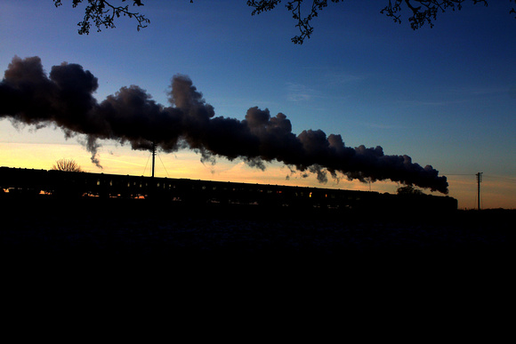 BR Standard Class 7 No 70013 'Oliver Cromwell' is silhouetted against  the setting sun at the Quorn Straight on 29.12.14 with 1500 Leicester North - Loughborough GCR Christmas Holiday Service