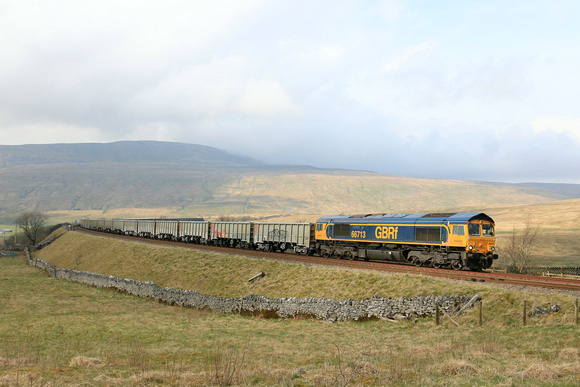 GBRf Class 66 No 66713 'Forest City' at Ribblehead on 26.3.24 with 6E69 1254 Ribblehead Vq Gbrf to Hunslet Tilcon Gbrf loaded stone wagons