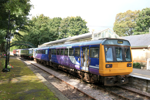 Preserved Pacer Class 142 No 142078 waits at Stanhope station, Weardale Railway on 28.9.24 with 1410 service to Bishop Auckland West service. Behind stabled is Class 122 DMBS E 55012 and Mk3 ex HST bu