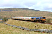 A grubby GBRf Class 66 No 66759 'Chippy' approaches Ribblehead station on 27.3.24 with 4N00 0923 Carlisle N.Y. to Clitheroe Castle Cement Gb empty cement tanks