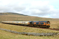 A grubby GBRf Class 66 No 66759 'Chippy' at Ribblehead on 27.3.24 with 4N00 0923 Carlisle N.Y. to Clitheroe Castle Cement Gb empty cement tanks