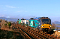 DRS 68003 'Astute' leads 2 Nuclear Flasks with DRS 68006 in green livery (HVO fuel) at rear on 11.1.22 at Arnside with 6C51 1247 Sellafield B.N.F. to Heysham Harbour P.S. working