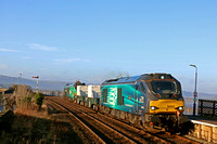 DRS 68003 'Astute' leads 2 Nuclear Flasks with DRS 68006 in green livery (HVO fuel) at rear on 11.1.22 enters Arnside Station with 6C51 1247 Sellafield B.N.F. to Heysham Harbour P.S. working